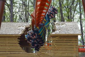 This image show the near-miss fly-thru element when the coaster track breaks through a barn.