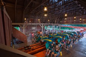 In this image riders are loading onto the winged-coaster in the launch station.