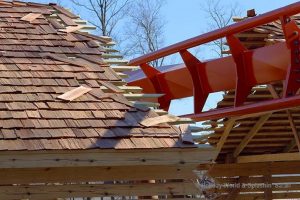 This image is a close of the near miss element showing the coaster track breaking through the barn.